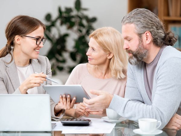 mature-couple-listening-to-agent-making-presentati-ZSFXB8N.jpg